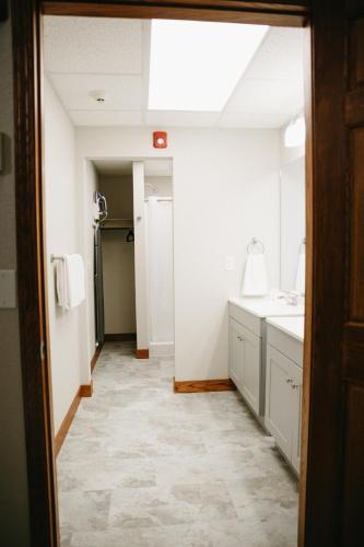 a bathroom with a sink and a mirror at Bricktown Inn in Camp Point