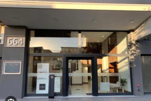 a building with a glass door with a sign on it at Concep Centro Freiré-Tucapel in Concepción