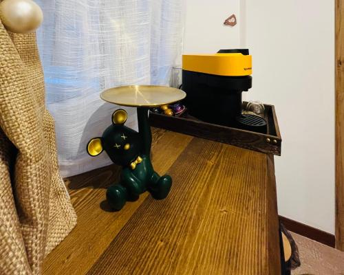 a toy cat with a table on the floor at Emilysuites - Malaga Centro Historico in Málaga