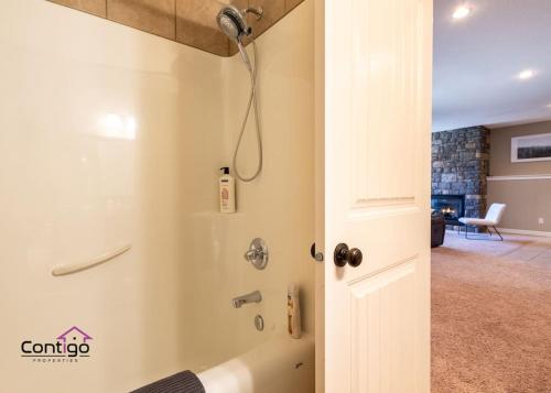 a shower in a bathroom with a shower backdoor at Peaceful 2 BD Oasis, Bsmt Suite, Private Terrace, Near YQL in Lethbridge
