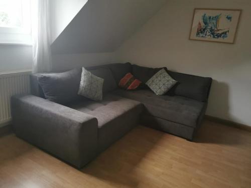a couch in a living room with pillows on it at s´Paradies Ferienwohnung in Beilngries