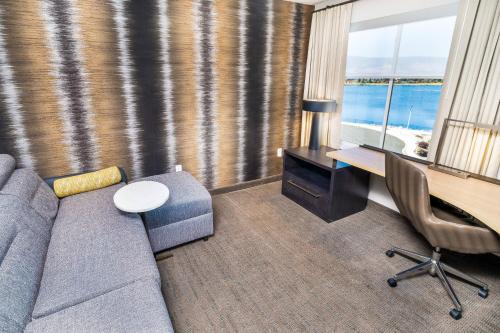 a living room with a couch and a table and a desk at Residence Inn by Marriott Reno Sparks in Sparks