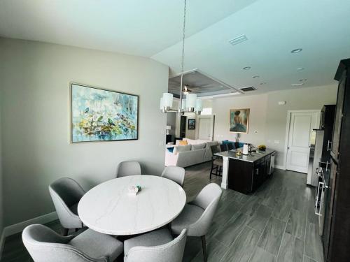 a living room with a white table and chairs at Newly built Villa Ballerina with heated pool and incredible view into beautiful Arrowheadcanal in Cape Coral