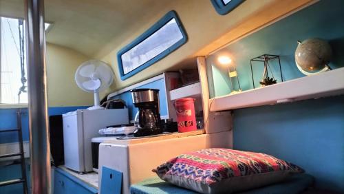 a small room with a bed and a desk with a pillow at La Perle d'orient A man donné in Gruissan