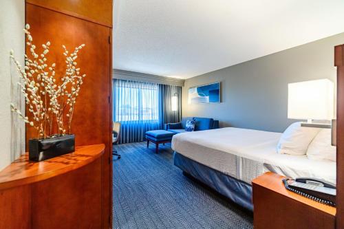 a hotel room with a bed and a desk at Courtyard Biloxi North/D'Iberville in Biloxi