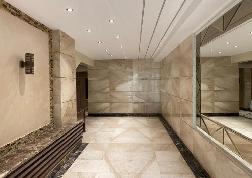 a hallway with a mirror and a tile floor at Heliopolis pearl/ furnished apartment in Cairo