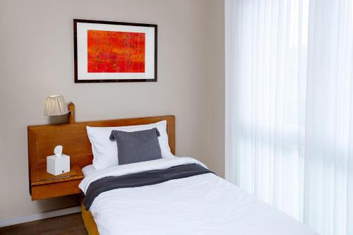 a bedroom with a bed and a picture on the wall at Hotel Regina -Garni Köln in Cologne