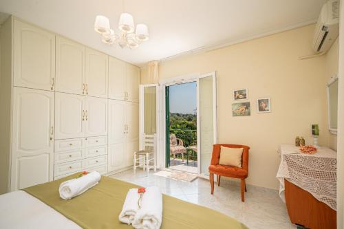 a bedroom with a bed and a table and a chair at Ariadni Sea View Apartment in Minia