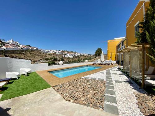 a swimming pool in the backyard of a house at Casa Amarela Alojamento Local in Mértola