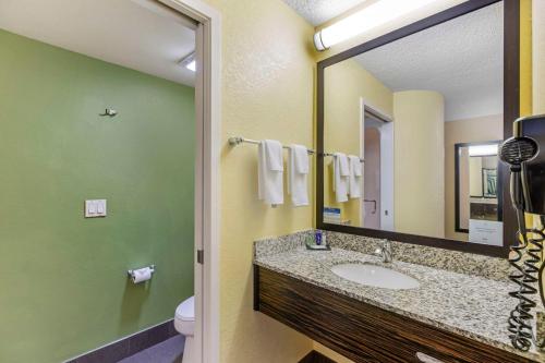 a bathroom with a sink and a mirror at Sleep Inn Denver Tech Greenwood Village in Greenwood Village