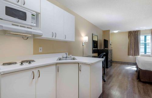 a kitchen with a sink and a microwave at Extended Stay America Suites - Pleasant Hill - Buskirk Ave in Pleasant Hill