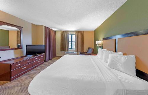 a hotel room with a large bed and a television at Extended Stay America Suites - Los Angeles - Valencia in Stevenson Ranch