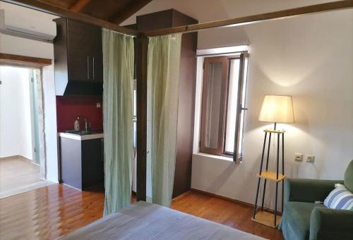 a bedroom with a bed and a living room with a couch at Halepouri Apartment in Chania Town
