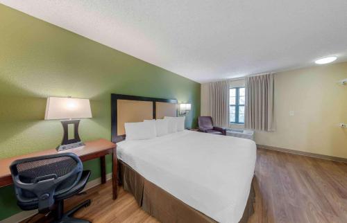 a large bed in a room with a desk and a chair at Extended Stay America Suites - Los Angeles - Arcadia in Arcadia