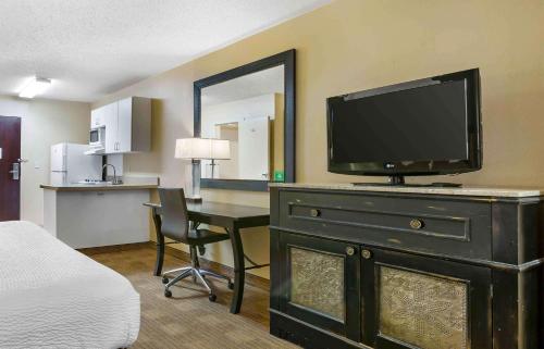a hotel room with a television on top of a dresser at Extended Stay America Suites - Albuquerque - Rio Rancho in Rio Rancho