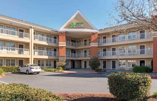 a hotel with a car parked in a parking lot at Extended Stay America Suites - Sacramento - White Rock Rd in Rancho Cordova