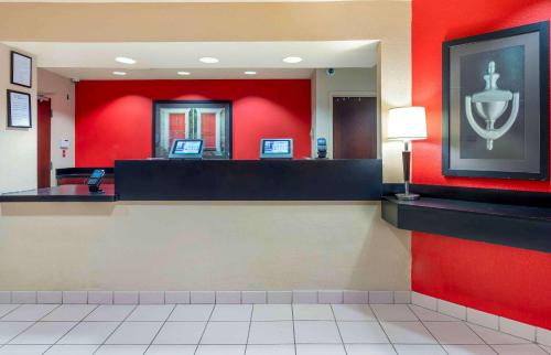 a waiting area of a fast food restaurant with red walls at Extended Stay America Suites - Chicago - Schaumburg - I-90 in Schaumburg