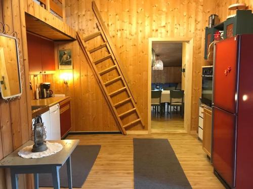 a kitchen with a spiral staircase in a tiny house at Romslig hytte nær R7, Ål sentrum, fjell & skianlegg in Liagardane