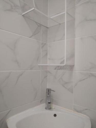 ein weißes Bad mit einem Waschbecken und einem WC in der Unterkunft Très joli petit studio aux portes Paris in Ivry-sur-Seine