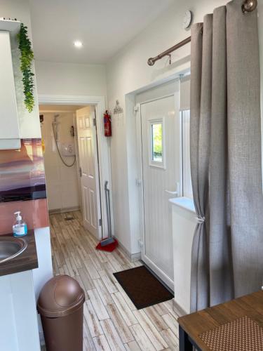 a kitchen with a sink and a refrigerator at The Casan in Letterkenny