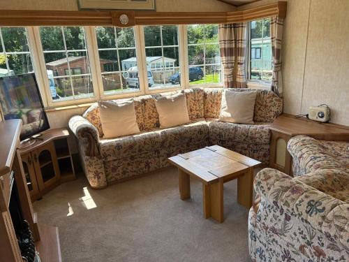 a living room with a couch and a table at Stunning Holiday Home Whithorn3 in Newton Stewart