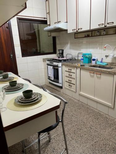 a kitchen with a table with plates on it at Lindo quarto próximo ao metrô ! in São Paulo