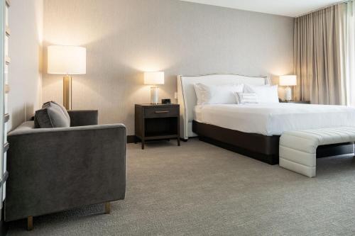 a hotel room with a bed and a couch at SpringHill Suites by Marriott Chicago Chinatown in Chicago
