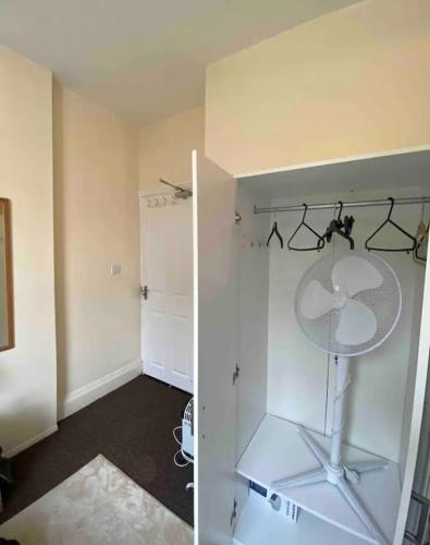 an empty room with a closet with a white refrigerator at RHB Apartments in Leicester