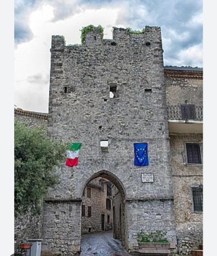 a castle with two flags on the side of it at Giada House in Vico nel Lazio