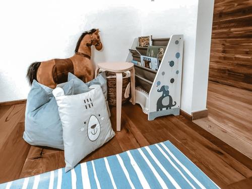 a room with a horse standing next to a bed at CLOUD 9 - Penthouse with Private Rooftop Whirlpool & Terrace in Zillertal, presented by AlpenLuxus in Fügen