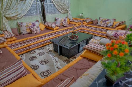 a living room with a couch and a table at Riad Dar Fadma in Ouarzazate