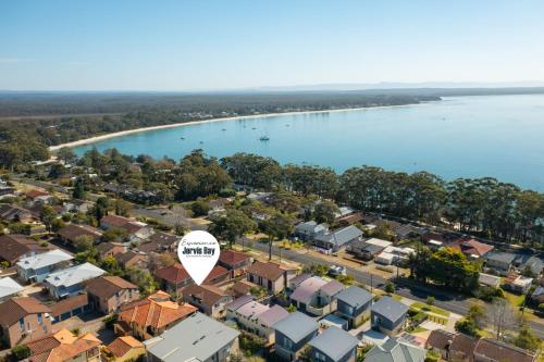 an aerial view of a suburb with a body of water at Orana by Experience Jervis Bay in Vincentia