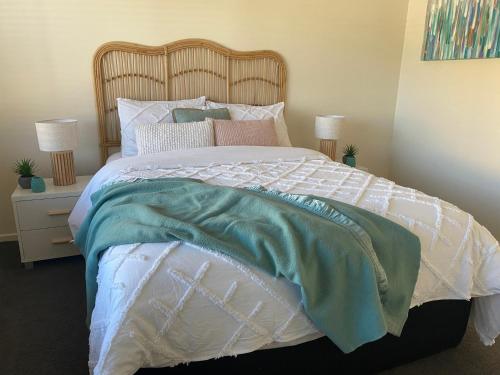 a bedroom with a large bed with a wooden headboard at Perfect on Orton in Ocean Grove