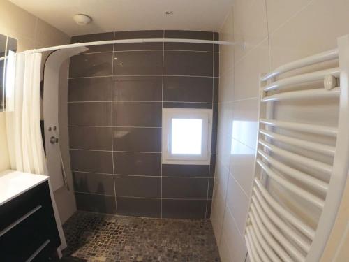 a bathroom with a shower with a window in it at bnbgônes -LE COSY CRAPONNOIS- Craponne Centre - Proche Lyon - Wifi in Craponne