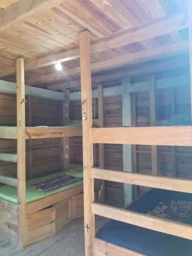 a room with two bunk beds in a cabin at Ch'i Bocól Community Hostel in Lanquín