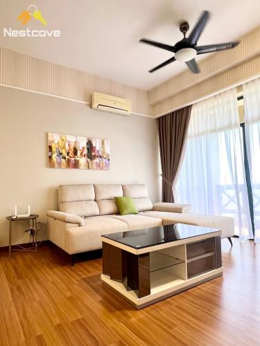 a living room with a couch and a ceiling fan at Costa Mahkota Suites Malacca Central By Nestcove in Melaka