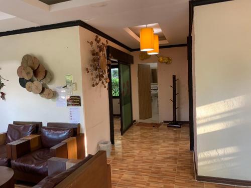 a living room with a couch and a large mirror at สงขลาคีรี รีสอร์ท SongkhlaKeeree Resort in Ban Khao Rup Chang