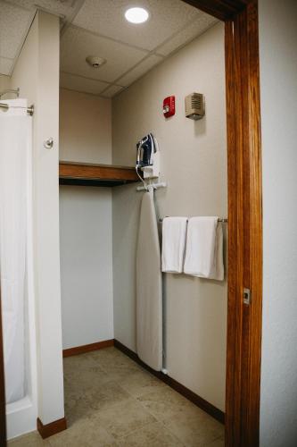 a room with a refrigerator and towels on a wall at Bricktown Inn in Camp Point