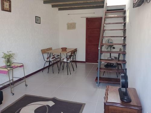 a room with a table and chairs and a ladder at La Baquiana 2 in Mercedes