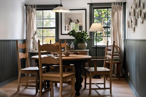 a dining room with a table and chairs at Innisfree in Daylesford
