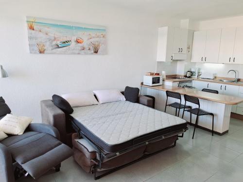 a room with a bed in a kitchen with a table at Estrella del Mar in El Médano