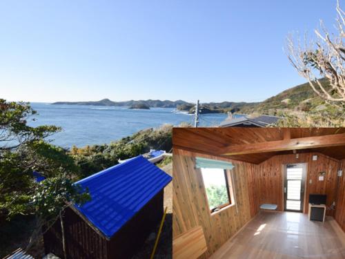 a house with a blue roof with a view of the ocean at Tonosaki Bungalow & BBQ in Tsushima