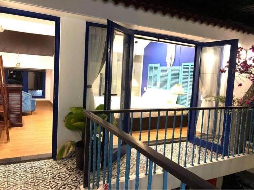 a balcony with sliding doors with a view of a room at PHỐ CHỢ ĐÊM Villa - Near Hoi An Old Town 200m in Hoi An