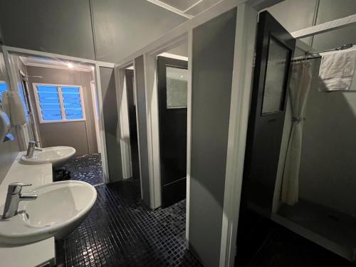 a bathroom with two sinks and a shower at Biloela Hotel in Biloela