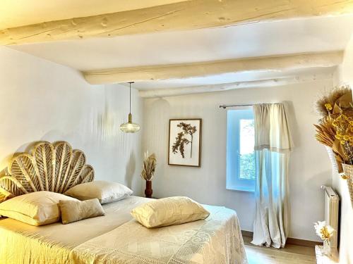 a bedroom with a bed and a window at Maison en pierre avec piscine, 6 couchages, située au cœur de Mallemort, Provence. - FR-1-658-25 in Mallemort