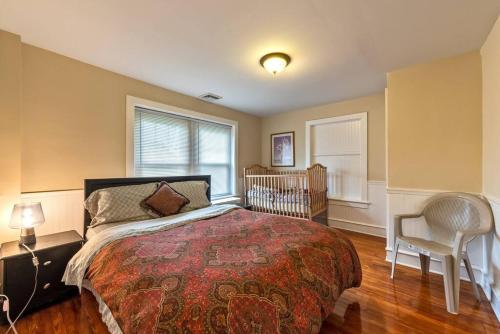 a bedroom with a bed and a crib in it at 5 Bdrm House (Sleeps 10) Horsham-Philadelphia in Horsham