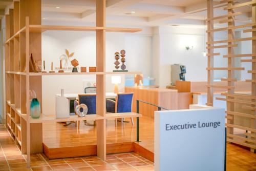 a room with wooden shelves and a sign that reads executive lounge at MARISSA RESORT sazanseto suo-oshima in Suo Oshima