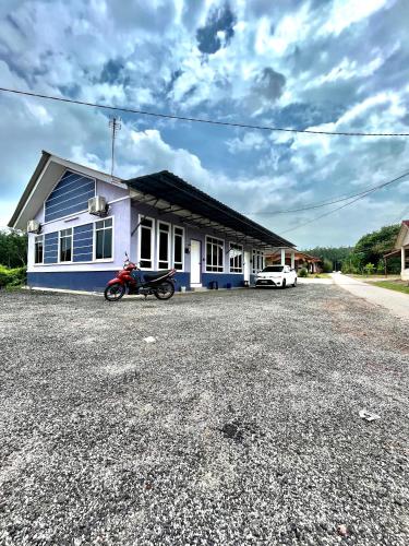 a motorcycle parked in front of a house at Zaf Homestay Pendang in Pendang