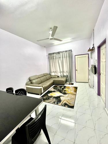 a living room with a couch and a table at Zaf Homestay Pendang in Pendang