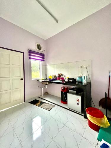 a room with a kitchen with a white door and a window at Zaf Homestay Pendang in Pendang